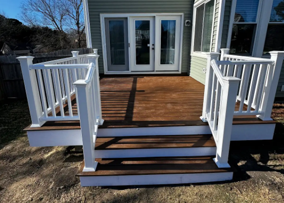 Finished custom Trex composite deck with white railings and matching stairs in Fuquay-Varina, NC, built by Titan Decks.