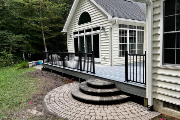 Completed Trex Foggy Wharf composite deck resurfacing with black aluminum Signature railings by Titan Decks.