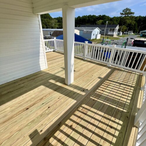 Wood-Deck-Porch-Sunlight-NC Sunlight filtering through a new wood deck and porch structure built by Titan Decks in North Carolina.