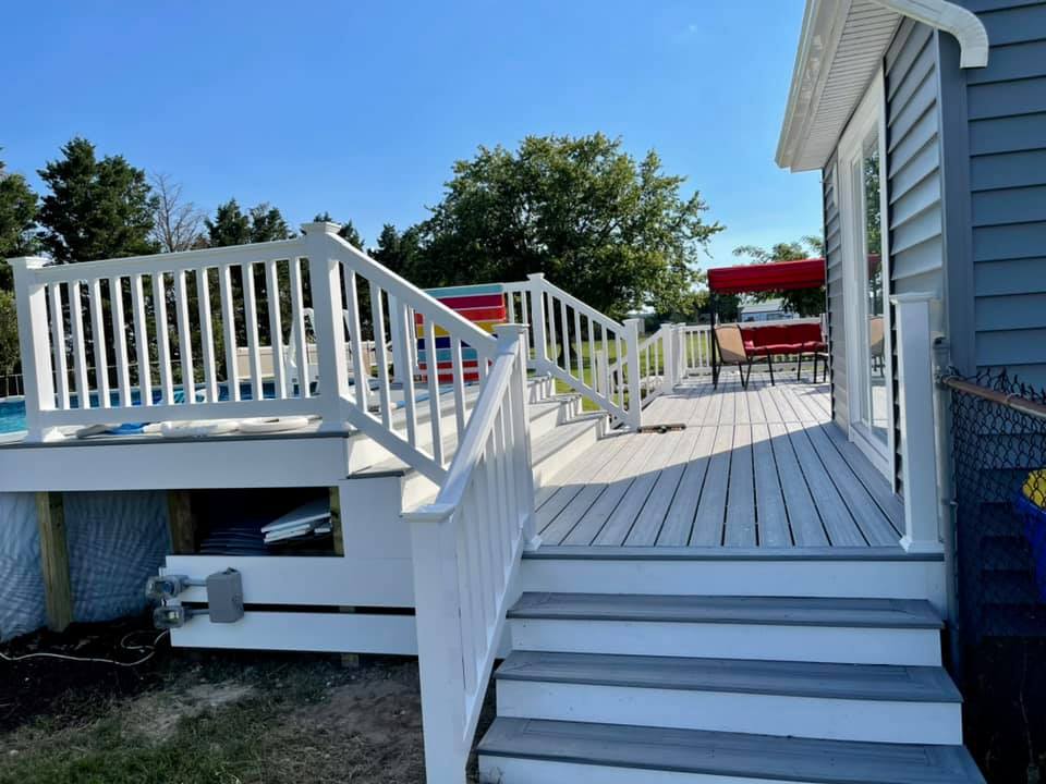 After photo of a Trex Foggy Wharf composite deck resurface featuring custom white vinyl railings by Titan Decks.