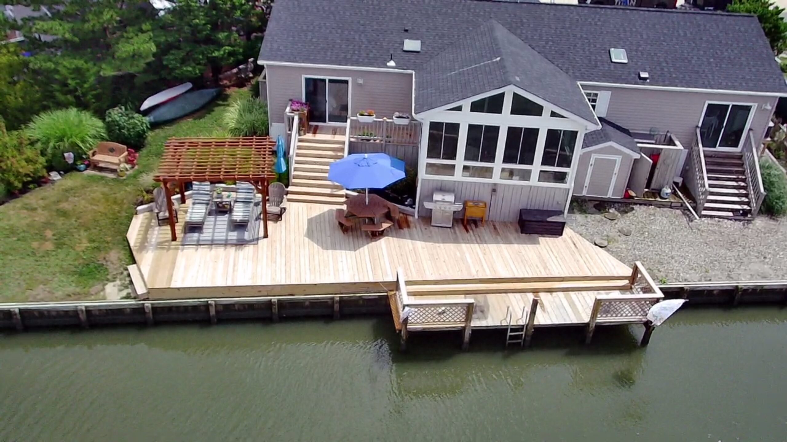 New custom pressure-treated wood deck featuring a natural finish, built by Titan Decks in a Central North Carolina backyard.