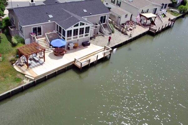 Aerial view of a completed waterfront wood deck, pergola, and boat dock system in North Carolina by Titan Decks.