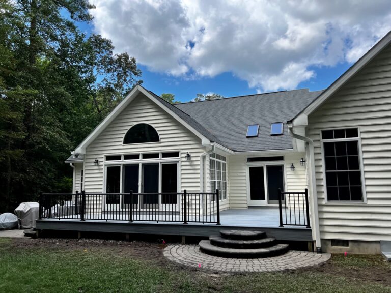 After photo of a finished Trex Foggy Wharf composite deck with black aluminum Signature railings by Titan Decks.