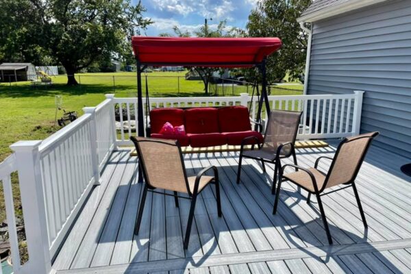 After photo of a Trex Foggy Wharf composite deck resurface featuring custom white vinyl railings by Titan Decks.