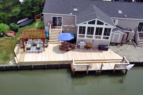 erial view of a completed custom wood deck, pergola, and waterfront dock in North Carolina by Titan Decks.