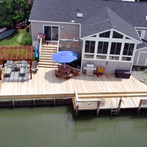 New custom pressure-treated wood deck featuring a natural finish, built by Titan Decks in a Central North Carolina backyard.