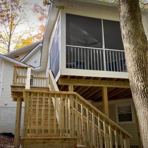 Custom-Wood-Stairs-Screened-Porch-NC Side view of custom wood stairs leading to an elevated screened-in porch in North Carolina by Titan Decks.