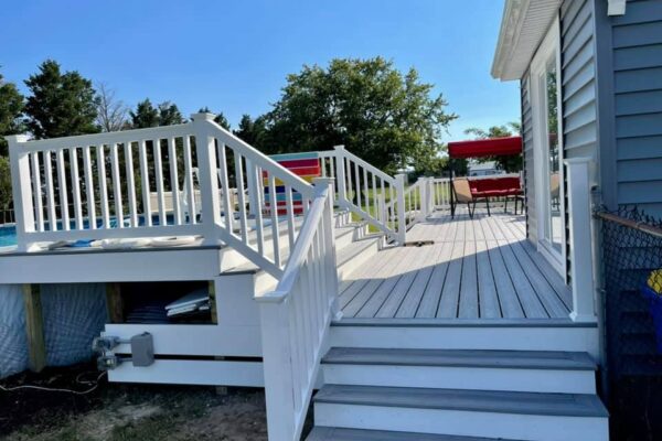After photo of a Trex Foggy Wharf composite deck resurface featuring custom white vinyl railings by Titan Decks.