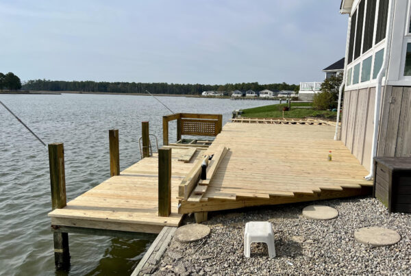 Professional installation of pressure-treated wood deck boards over a custom-framed foundation in North Carolina by Titan Decks.