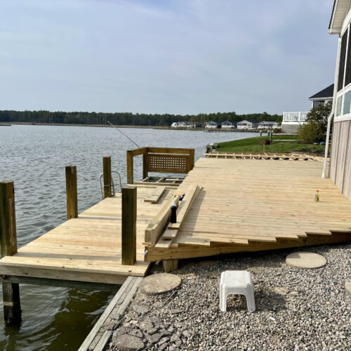 Wood-Deck-Board-Installation-NC Professional installation of pressure-treated wood deck boards over a custom-framed foundation in North Carolina by Titan Decks.