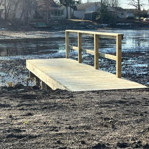 Side-View-Completed-Wood-Dock-NC Side view of a finished custom wood dock and deck built on a North Carolina shoreline by Titan Decks.