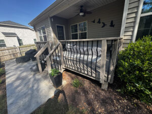 Aging wood deck with peeling stain and organic growth in Angier, NC, prior to a Trex resurface.