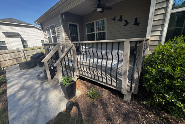 Aging wood deck with peeling stain and organic growth in Angier, NC, prior to a Trex resurface.