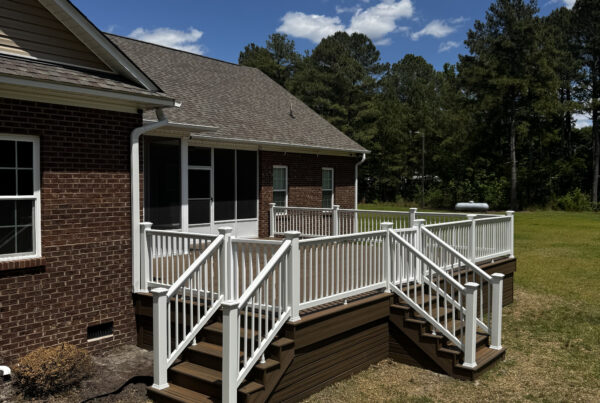 Full view of a custom Trex composite deck in Toasted Sand with white vinyl railings, built by Titan Decks in Roseboro, NC.