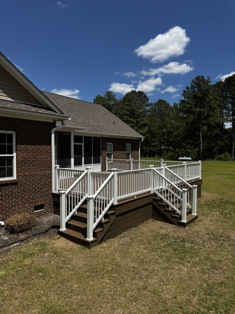 Full view of a custom Trex composite deck in Toasted Sand with white vinyl railings, built by Titan Decks in Roseboro, NC.