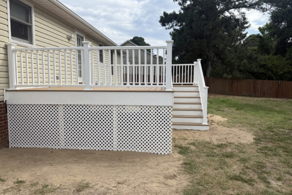 Trex Golden Hour deck with white composite railing and lattice skirting