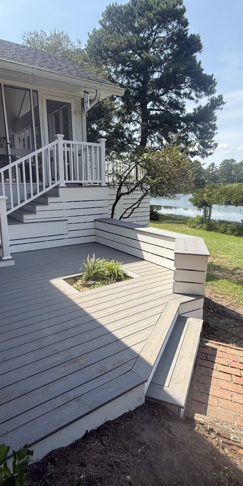 Resurfaced composite deck with built-in bench and lake view in North Carolina